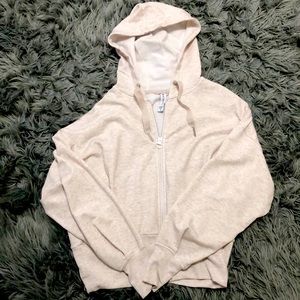 Cream colored white zip up hoodie.
